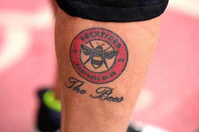 A fan of Brentford with a club emblem tattoo