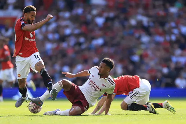 William Saliba of Arsenal under pressure from Mason Mount and Matheus Cunha