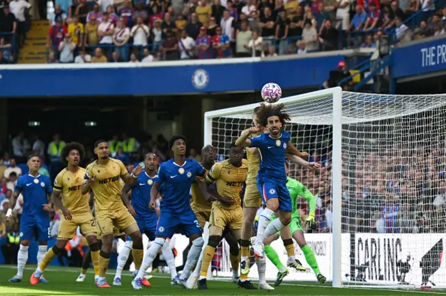 Marc Cucurella (R) rises at the near post to meet the ball