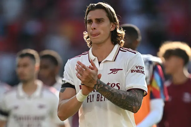 Riccardo Calafiori applauds fans on the pitch
