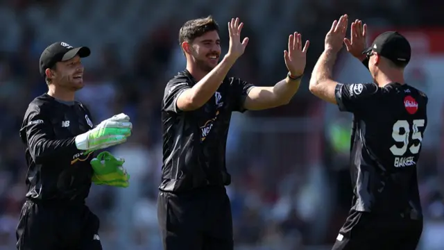 Josh Tongue of Manchester Originals celebrates with team mates Jos Buttler and Sonny Baker