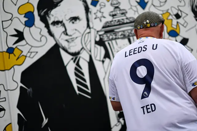 A Leeds fan arrives for the Premier League match