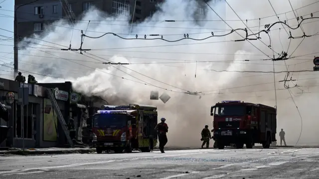 Firefighters work at the site of a Russian missile strike in Zaporizhzhia