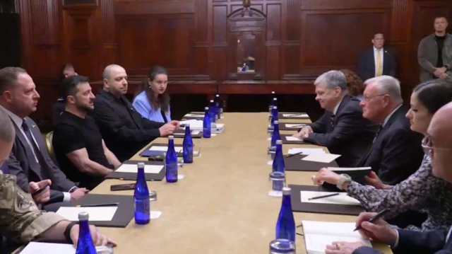 Zelensky and Kellogg pictured sat around a long table with their teams