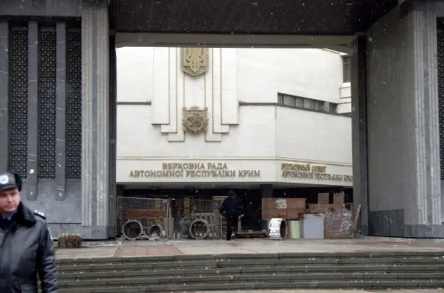The Crimean parliament in Simferopol was barricaded after being seized by mysterious masked commandos in unidentified green uniform