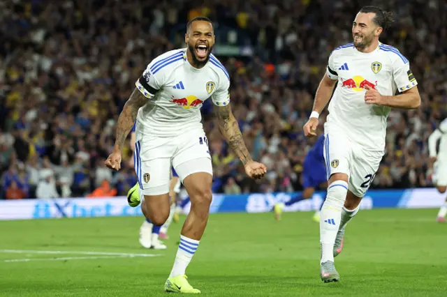 Lukas Nmecha (L) celebrates after scoring the opening goal