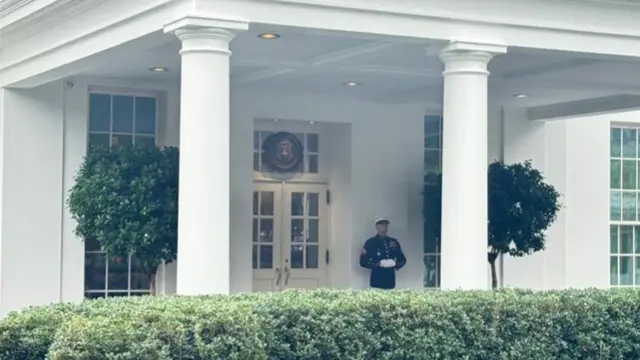 A Marine stands outside the White House