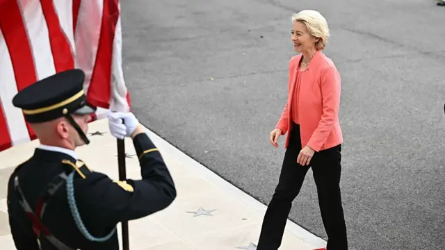 Ursula von der leyen in a pink jacket and black trousers