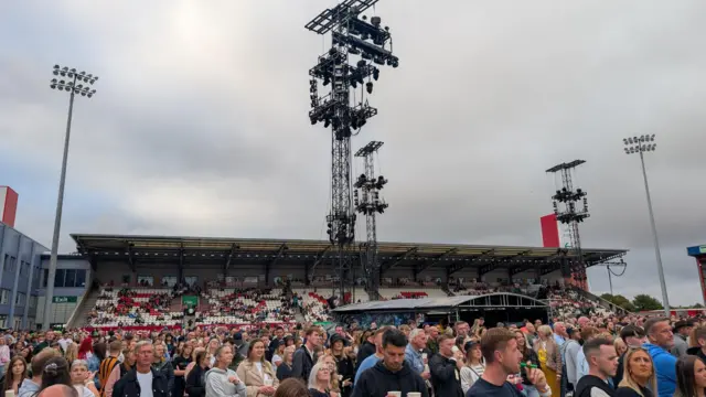 Crowds gathered in Craven Park stadium. The skies above are overcast and grey.