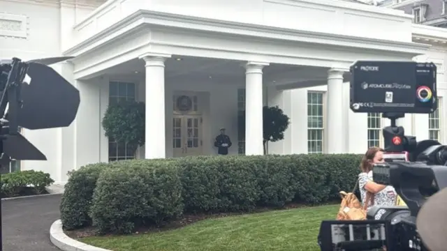 A Marine stands outside the White House