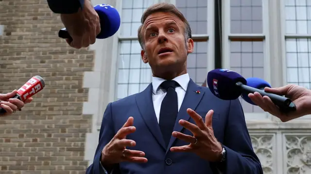 French President Emmanuel Macron speaks with the media after a meeting with U.S. President Donald Trump, Ukrainian President Volodymyr Zelenskiy and European leaders
