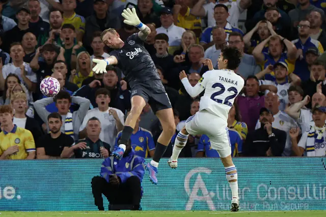 Jordan Pickford (L) comes out to block an attempt from Leeds United's Japanese midfielder #22 Ao Tanaka