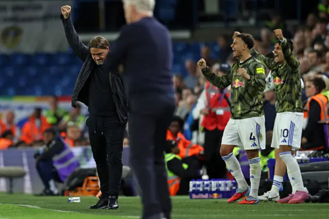 Leeds United's German head coach Daniel Farke (L) celebrates on the final whistle