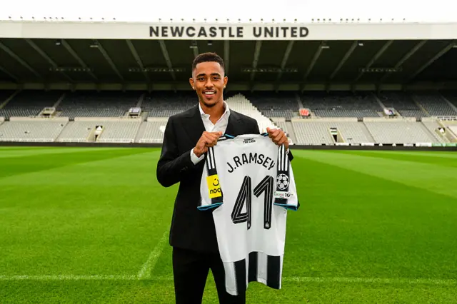 Jacob Ramsey holds up Newcastle shirt at St James' Park