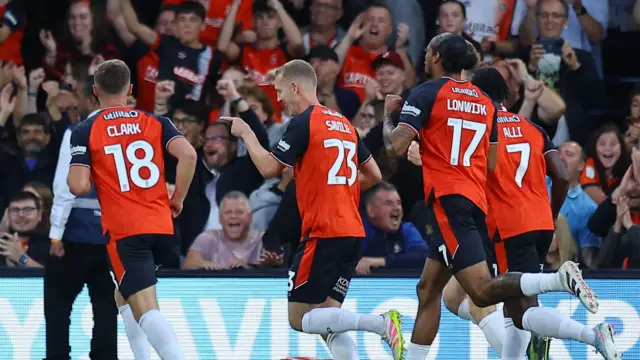George Savill celebrates giving Luton the lead against Wigan