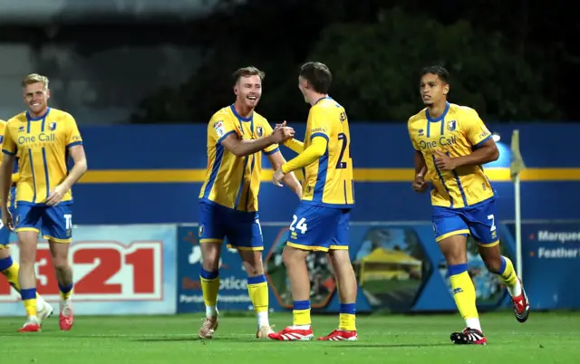 Jamie McDonnell celebrates scoring for Mansfield