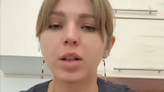 Krystina wearing star-themed earrings looks into the camera