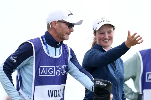 Lottie Woad smiling with her caddie