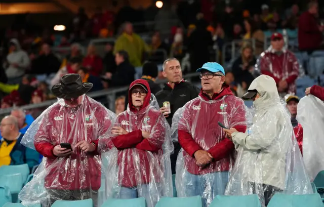 Fans braving the rain