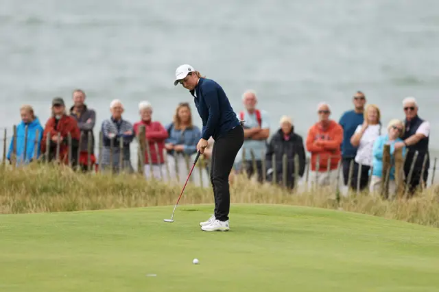 Lottie Woad putts on a green