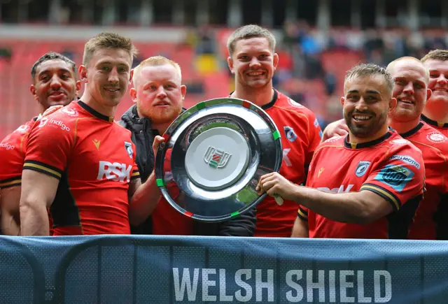 Josh Adams and Liam Belcher Captain of Cardiff Rugby are awarded the Welsh Shield following the United Rugby Championship match between Ospreys and Cardiff Rugby at the Principality Stadium on April 19, 2025 in Cardiff, Wales.