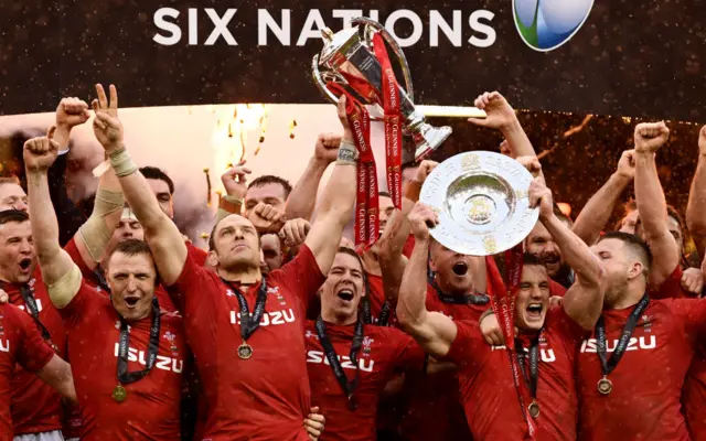 Wales captain Alun Wyn Jones and team mates celebrate with the Championship trophy after winning the Grand Slam after the Guinness Six Nations match between Wales and Ireland