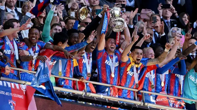 Marc Guehi and Joel Ward of Crystal Palace lift the FA Cup trophy
