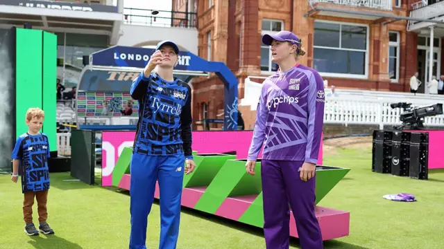 Charlie Dean of London Spirit tosses the coin alongside Hollie Armitage