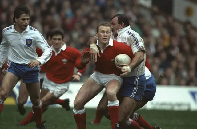Paul Thorburn (centre right) of Wales is tackled by Laurent Rodriguez (right) of France during the 1990 Five Nations Championship match between France and Wales at the Parc des Princes in Paris. France won the match 29-19