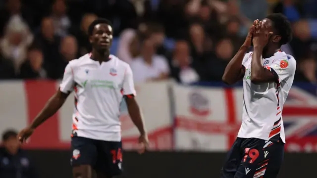 Amario Cozier-Duberry looks dejected after hitting the post for Bolton
