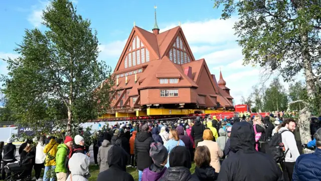 People watch as the Kiruna Church landmark is being moved on a specially designed trolley.