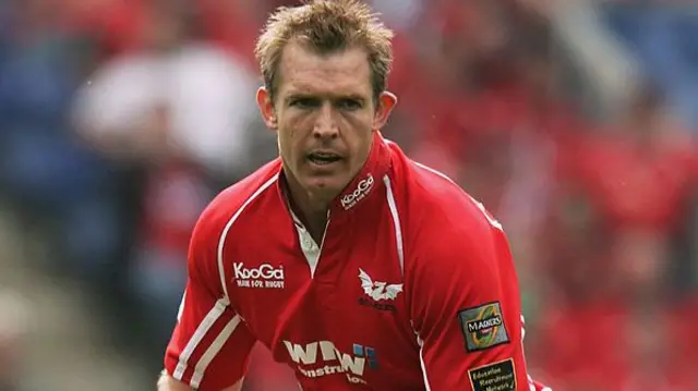 Dafydd James in a Scarletts red top. He has brown short hair and is mid game.