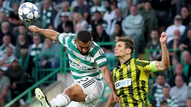 Cameron Carter Vickers of Celtic contends for the aerial ball with Alyaksandr Martynovic