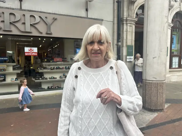 Jenny Tillier, photographed in Llanelli, wears a white jumper and has a blonde short bob and a full fringe.
