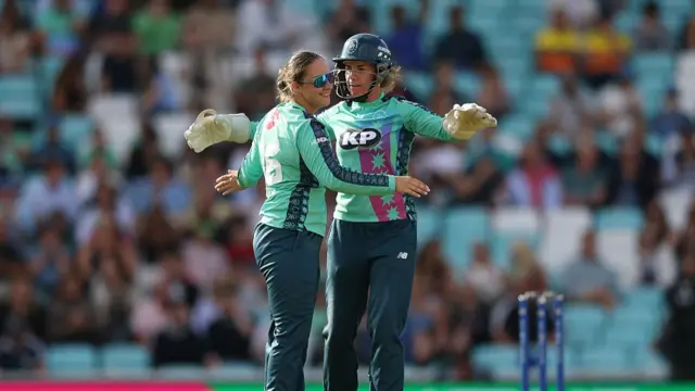 Alice Capsey of Oval Invincibles celebrates with teammate Lauren Winfield-Hill after taking the wicket of Grace Scrivens of Trent Rockets