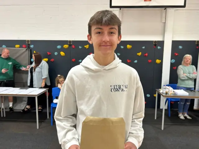 Sam holding his results