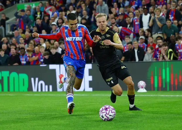 Palace and Fredrikstad players duel for the ball on the wing