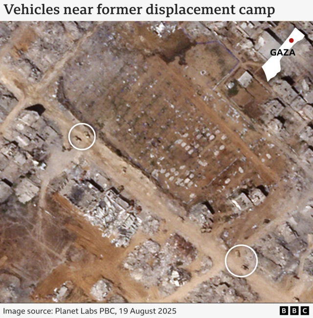 A satellite image of vehicles near a former displacement camp.