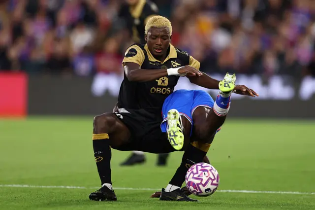 Fredrikstad player tackles a Palace player