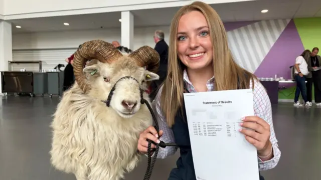 Milly Johnson, 16, and her sheep Kevin receiving her GCSE results at Tarleton Academy near Preston, Lancashire.
