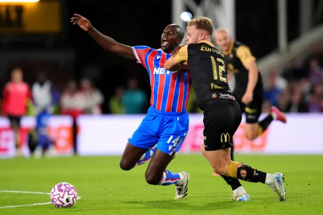 Fredriksen hauls down Mateta on the halfway line