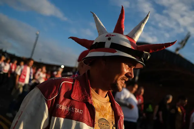 Fredrikstad fan arrives with a red and white horned hat