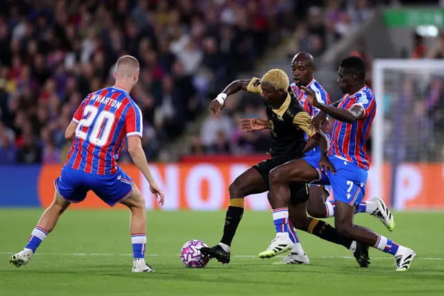Palace players swarm around a Fredrikstad player in an attempt to win the ball