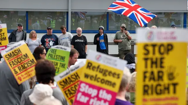 Protesters from the group Save Our Future & Our Kids Future demonstrate against uncontrolled immigration outside the Cladhan Hotel on August 16, 2025 in Falkirk, Scotland.