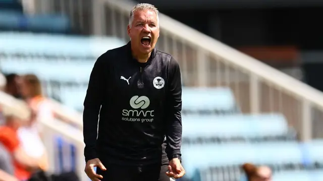 Peterborough boss Darren Fergsuon shouting instructions at his players from the sidelines