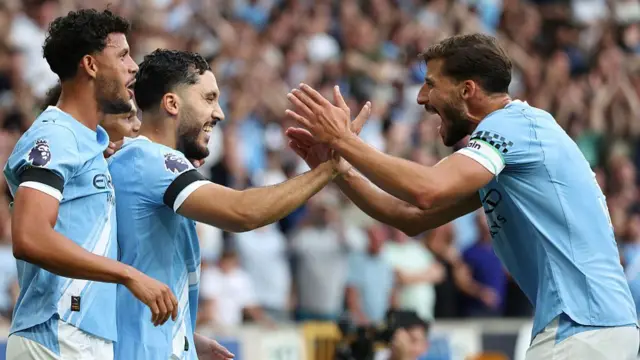 Ruben Dias celebrates with Rayan Cherki