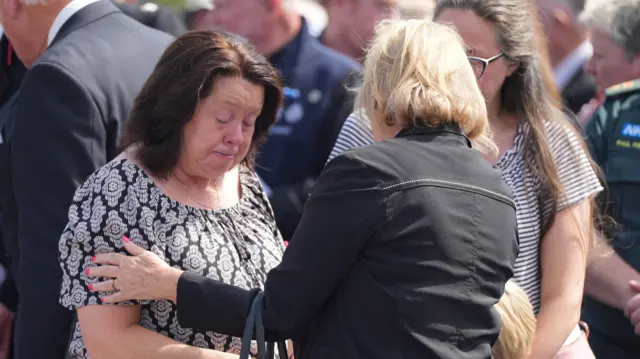 Tearful woman being comforted