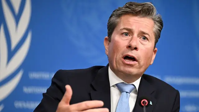 UN emergency relief coordinator Tom Fletcher in a black suit addressed the press in Geneva following the release of the IPC report