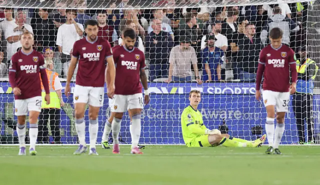 A dejected looking Mads Hermansen of West Ham United with team mates after Chelsea score a goal during the Premier League match between West Ham United and Chelsea at London Stadium on August 22, 2025 in London, England.