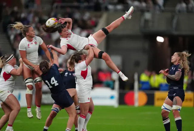 Abbie Ward of England catches the ball with support from teammate Maud Muir